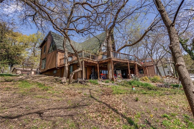 521 W Sugar Lake Dr, Mound City, KS 66056 - rear view of house with a deck and log veneer siding