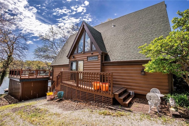 521 W Sugar Lake Dr, Mound City, KS 66056 - back of house with a shingled roof, a deck, and faux log siding