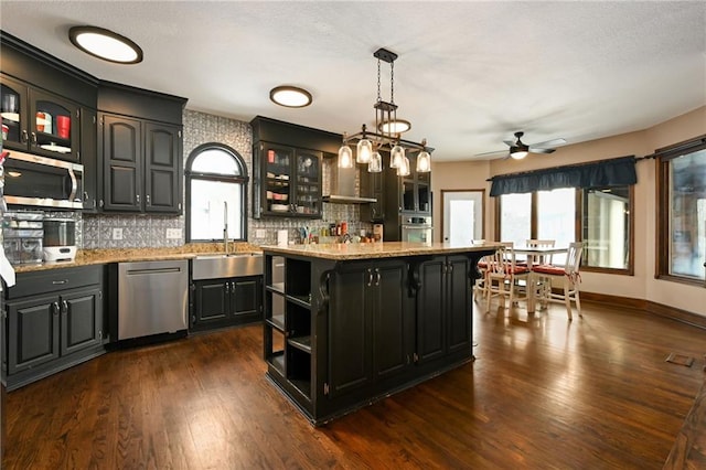 4353 NW State Route Ff, Adrian, MO 64720 - kitchen with decorative backsplash, a healthy amount of sunlight, open shelves, and stainless steel appliances