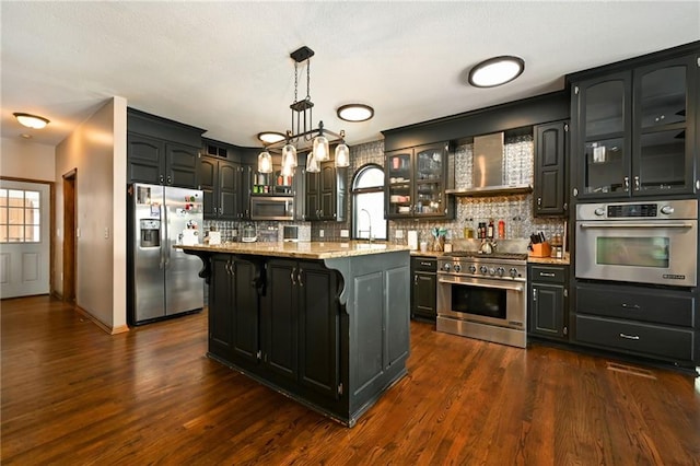 4353 NW State Route Ff, Adrian, MO 64720 - kitchen featuring glass insert cabinets, appliances with stainless steel finishes, a kitchen breakfast bar, and decorative backsplash
