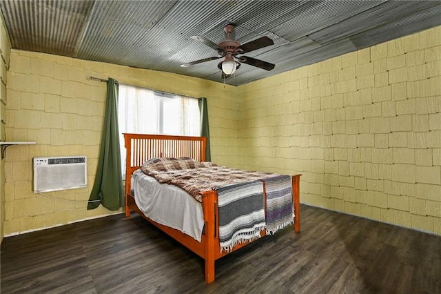 4353 NW State Route Ff, Adrian, MO 64720 - bedroom with concrete block wall, a ceiling fan, dark wood finished floors, and a wall mounted air conditioner