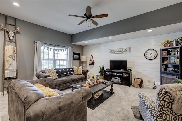 living area featuring recessed lighting, wood walls, carpet, and ceiling fan