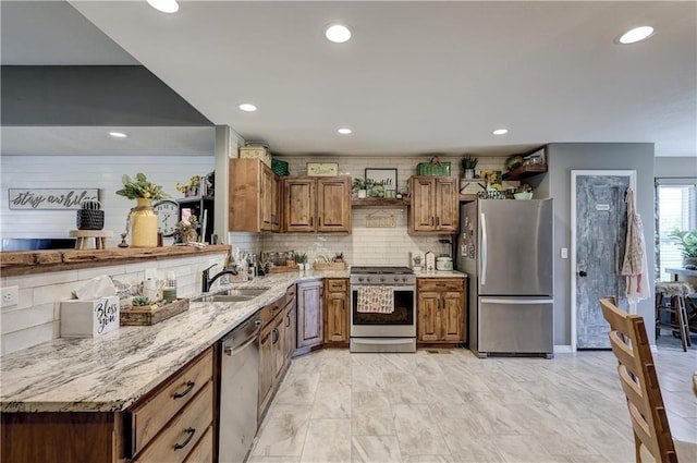 kitchen with a sink, decorative backsplash, brown cabinetry, and stainless steel appliances