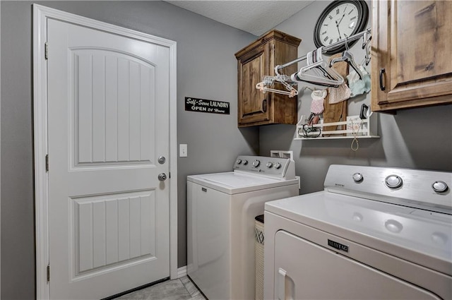 laundry area featuring separate washer and dryer and cabinet space