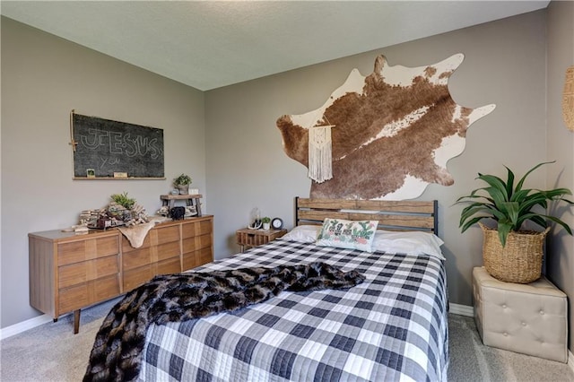 bedroom with baseboards and carpet
