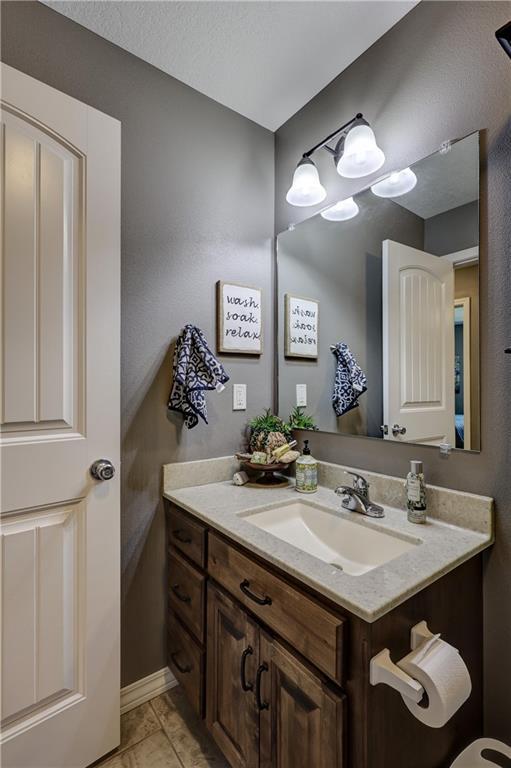 bathroom featuring vanity and marble finish floor
