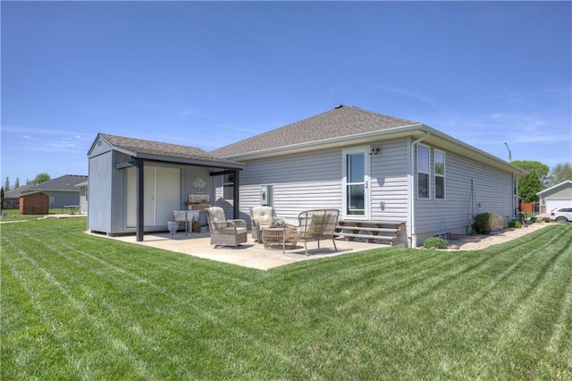 rear view of property featuring a yard, a patio, an outbuilding, and entry steps