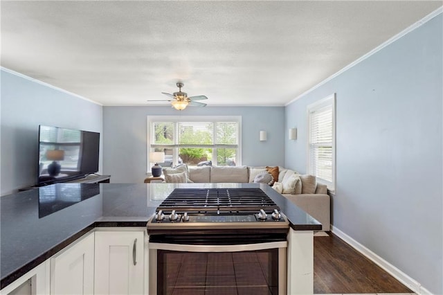 2014 W 74th St, Prairie Village, KS 66208 - kitchen with gas range, open floor plan, dark countertops, ornamental molding, and white cabinets