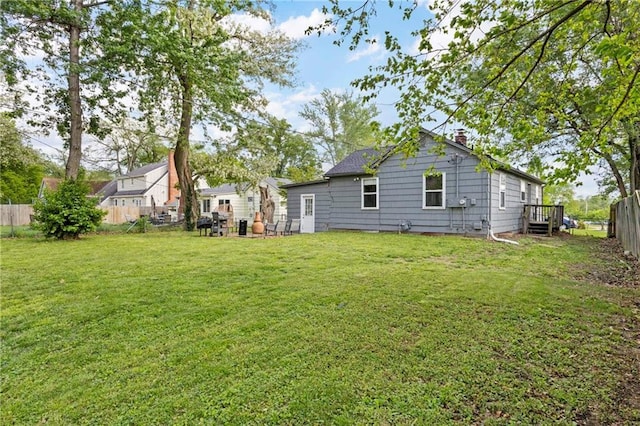 2014 W 74th St, Prairie Village, KS 66208 - rear view of house featuring a chimney and a wooden deck