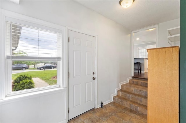 2014 W 74th St, Prairie Village, KS 66208 - foyer featuring stone finish flooring, baseboards, and stairway