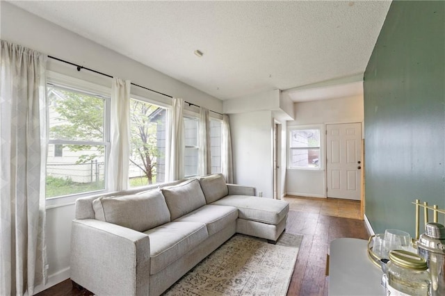 2014 W 74th St, Prairie Village, KS 66208 - living area with plenty of natural light, hardwood / wood-style floors, baseboards, and a textured ceiling