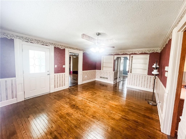 628 S Clay St, Nevada, MO 64772 - unfurnished room featuring wood-type flooring, a textured ceiling, ceiling fan, and wainscoting