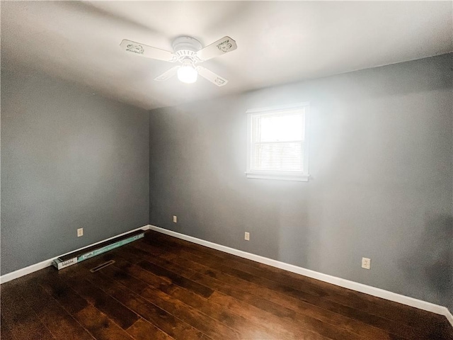 628 S Clay St, Nevada, MO 64772 - spare room with baseboards, ceiling fan, and dark wood-type flooring