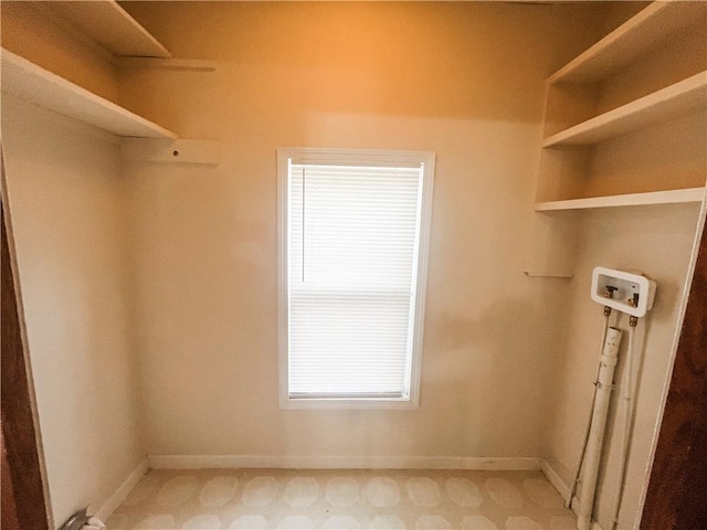 628 S Clay St, Nevada, MO 64772 - laundry area with baseboards, washer hookup, a healthy amount of sunlight, and laundry area