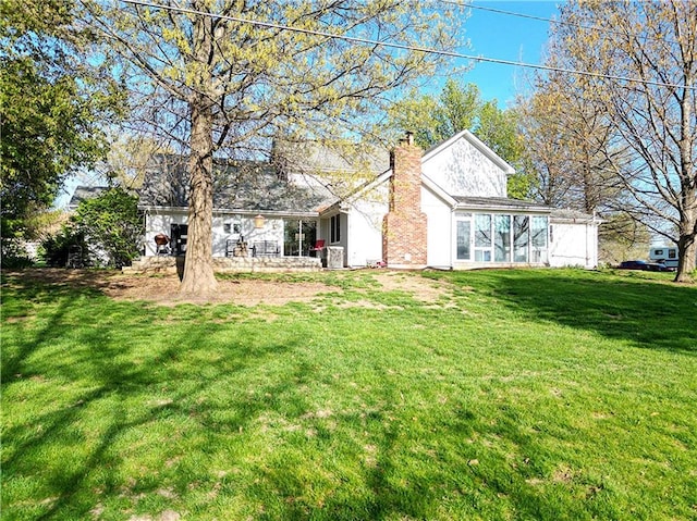 1502 Hillcrest Ct, Atchison, KS 66002 - rear view of house with a chimney and a yard