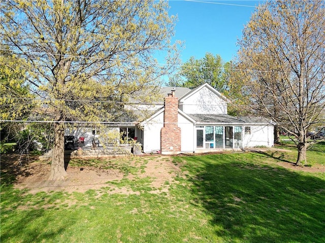1502 Hillcrest Ct, Atchison, KS 66002 - view of home's exterior with a chimney and a yard
