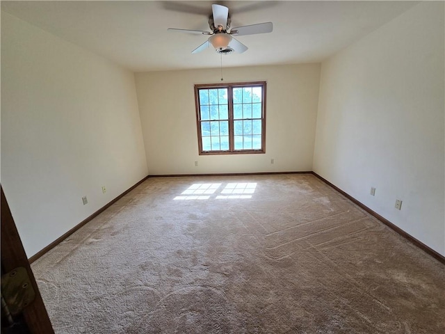 1502 Hillcrest Ct, Atchison, KS 66002 - empty room featuring carpet flooring, a ceiling fan, and baseboards