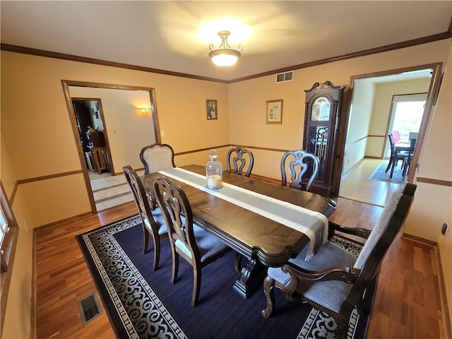 1502 Hillcrest Ct, Atchison, KS 66002 - dining space featuring light wood-type flooring and crown molding