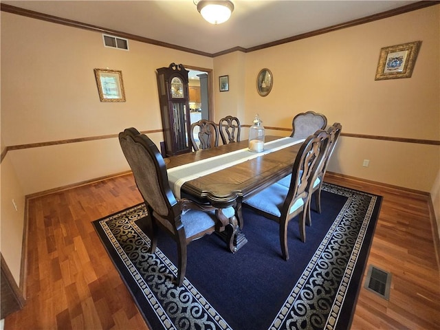 1502 Hillcrest Ct, Atchison, KS 66002 - dining area with wood finished floors, crown molding, baseboards, and decorative columns