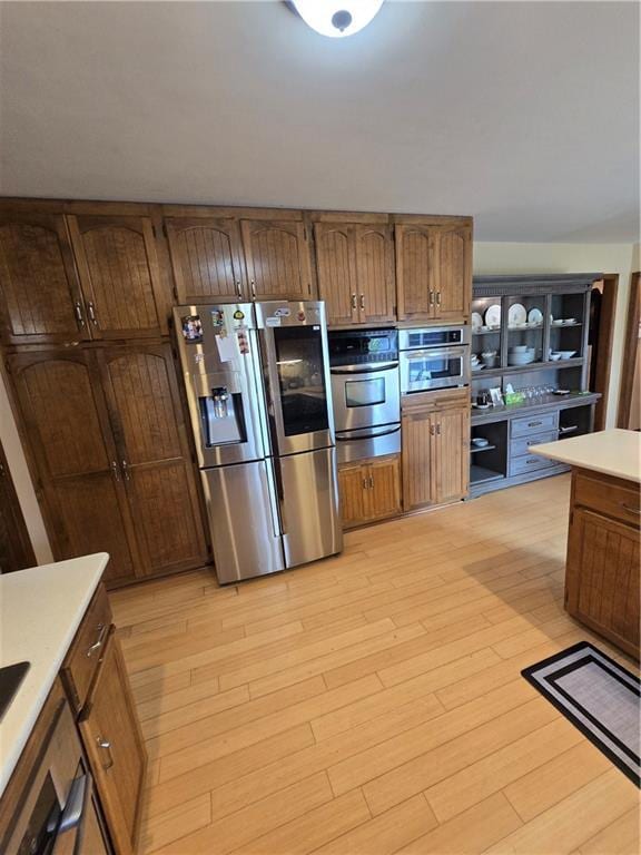 1502 Hillcrest Ct, Atchison, KS 66002 - kitchen featuring stainless steel appliances, a warming drawer, light countertops, and light wood-style floors