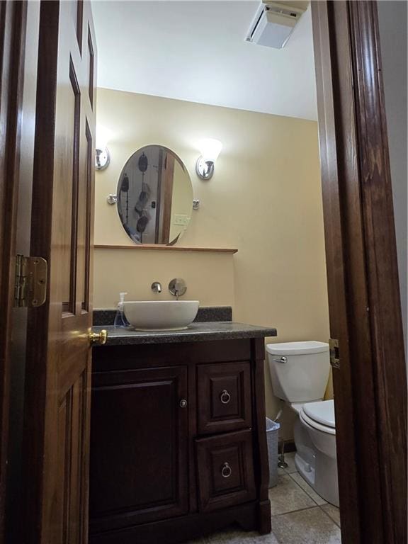 1502 Hillcrest Ct, Atchison, KS 66002 - bathroom with toilet, vanity, and tile patterned floors