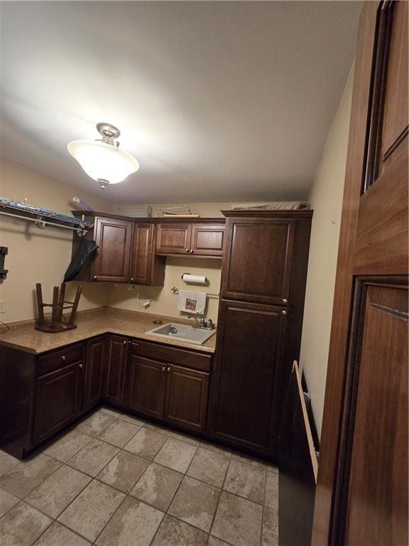 1502 Hillcrest Ct, Atchison, KS 66002 - kitchen with a sink, light countertops, dark brown cabinets, and light tile patterned flooring