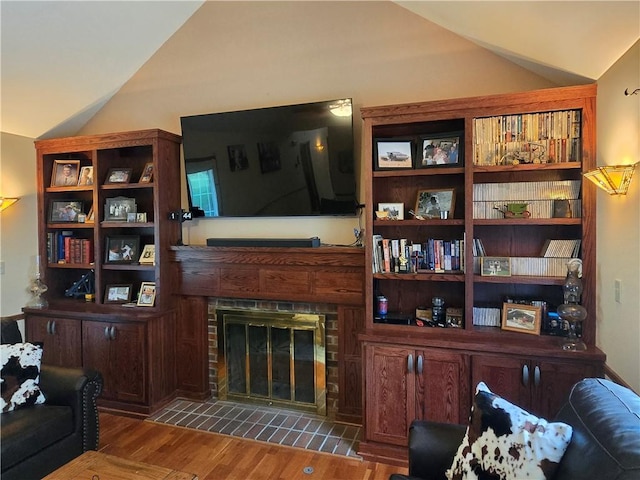 1502 Hillcrest Ct, Atchison, KS 66002 - living area with vaulted ceiling, wood finished floors, and a tiled fireplace
