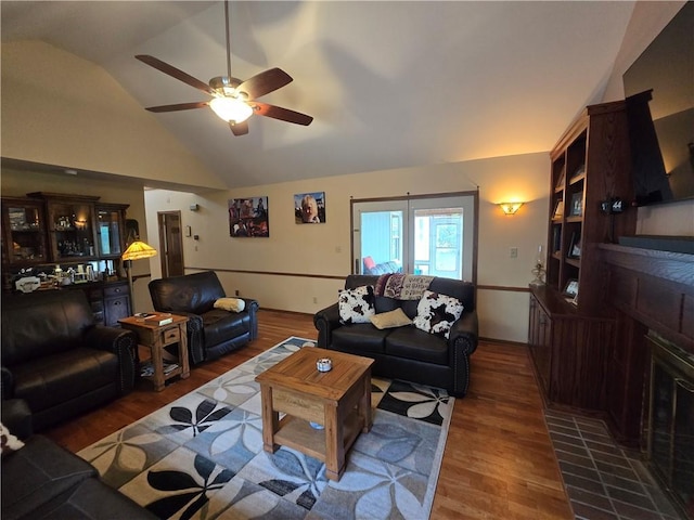 1502 Hillcrest Ct, Atchison, KS 66002 - living room featuring a fireplace with flush hearth, wood finished floors, vaulted ceiling, ceiling fan, and baseboards