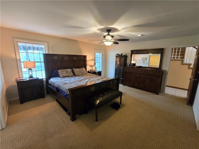 1502 Hillcrest Ct, Atchison, KS 66002 - bedroom with light carpet, multiple windows, baseboards, and a ceiling fan
