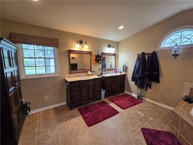 1502 Hillcrest Ct, Atchison, KS 66002 - full bath with two vanities, tile patterned flooring, recessed lighting, baseboards, and tiled bath