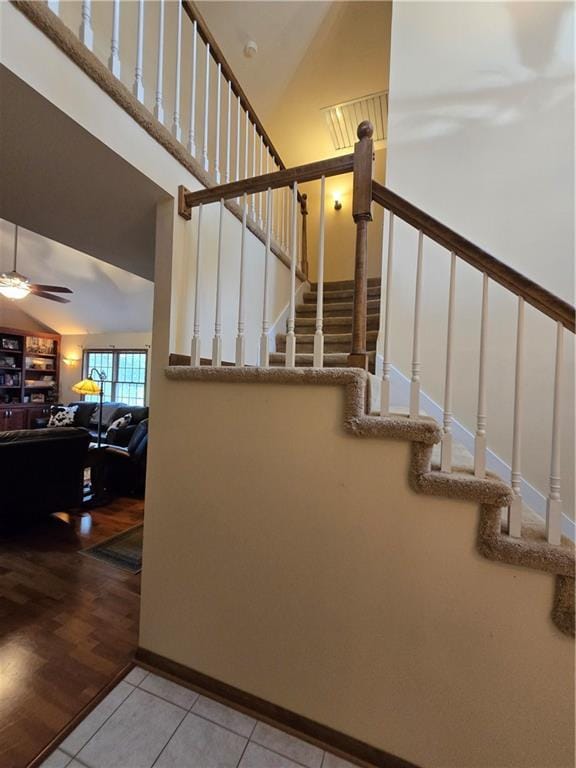 1502 Hillcrest Ct, Atchison, KS 66002 - stairs with ceiling fan, tile patterned flooring, and high vaulted ceiling