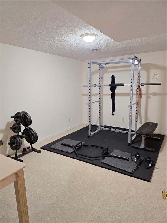 1502 Hillcrest Ct, Atchison, KS 66002 - exercise area with baseboards and a textured ceiling