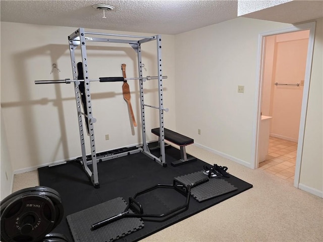 1502 Hillcrest Ct, Atchison, KS 66002 - workout area featuring baseboards and a textured ceiling