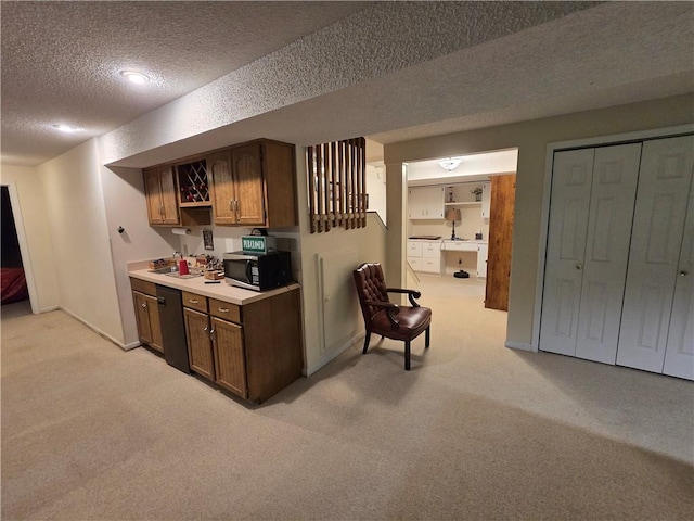 1502 Hillcrest Ct, Atchison, KS 66002 - kitchen featuring a textured ceiling, light carpet, stainless steel microwave, black dishwasher, and light countertops