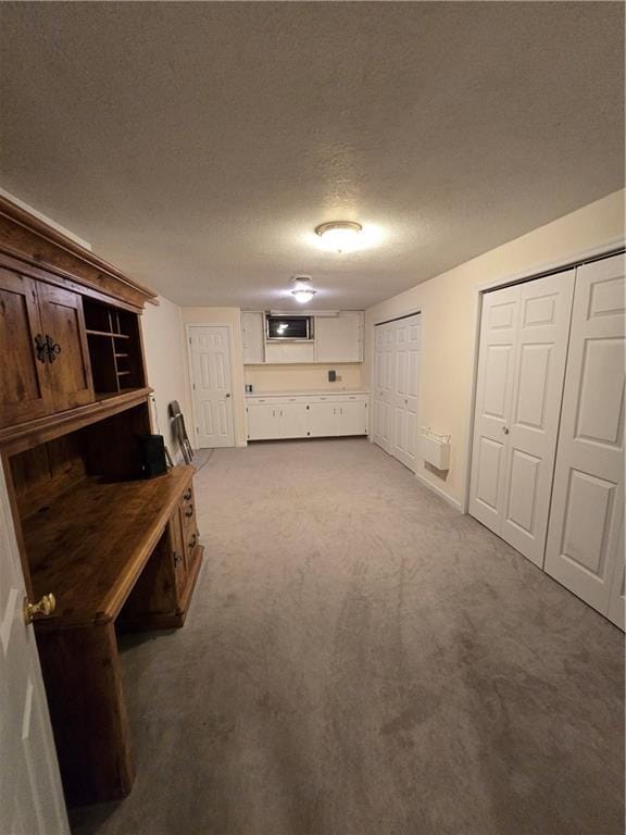 1502 Hillcrest Ct, Atchison, KS 66002 - below grade area featuring carpet and a textured ceiling