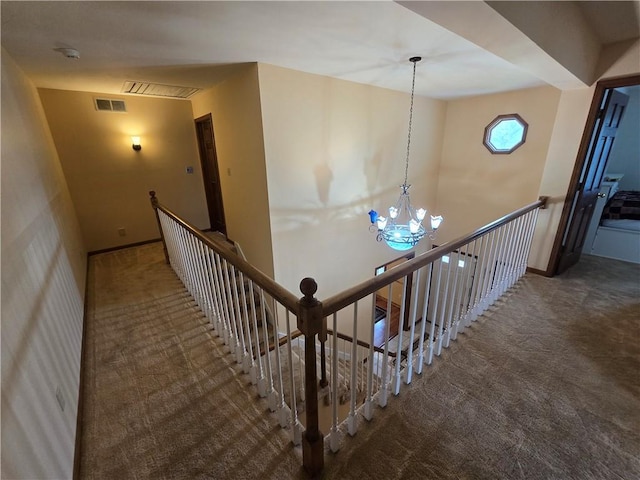 1502 Hillcrest Ct, Atchison, KS 66002 - stairs featuring carpet floors, a chandelier, and baseboards