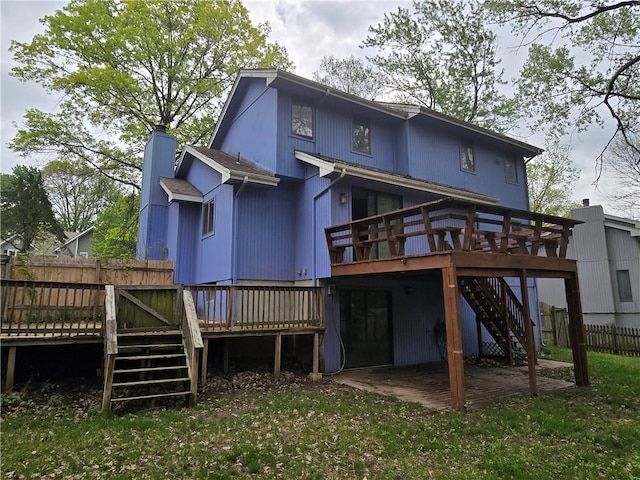 rear view of house featuring a deck, fence, a patio, and stairs
