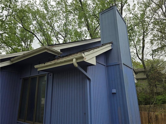 view of side of home featuring fence