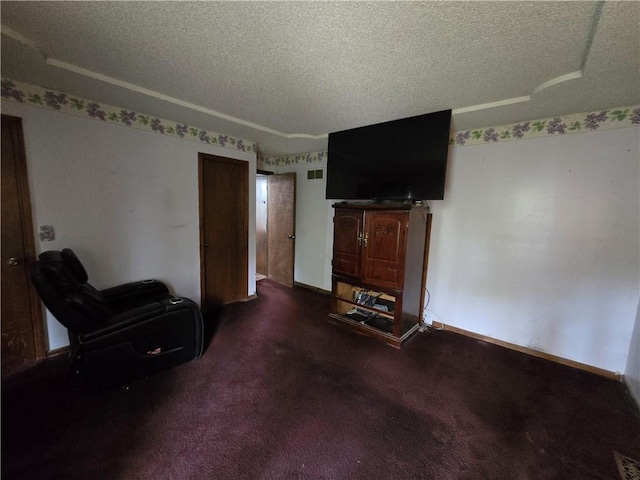 living area with a textured ceiling, visible vents, and baseboards