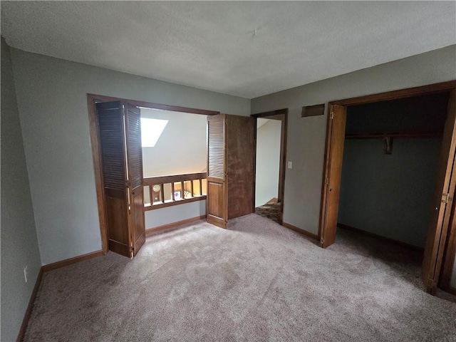 unfurnished bedroom featuring a closet, baseboards, and carpet floors