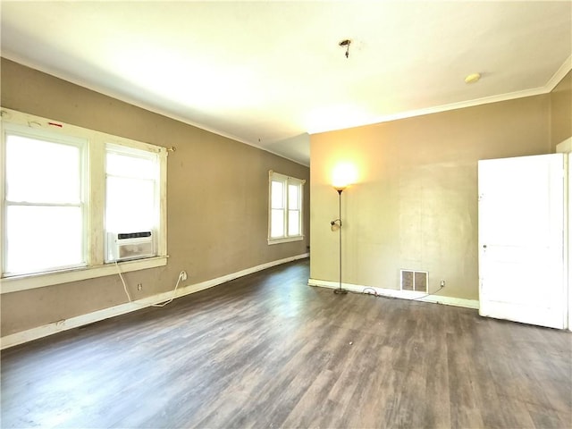 808 N Pine, Pittsburg, KS 66762 - unfurnished room featuring cooling unit, baseboards, visible vents, and dark wood finished floors