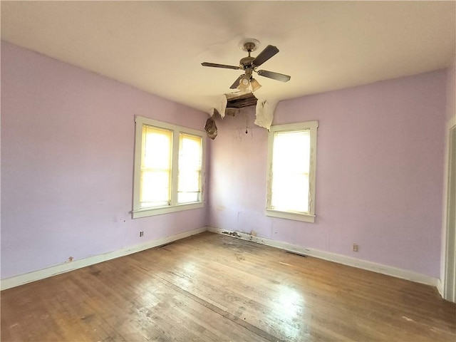 808 N Pine, Pittsburg, KS 66762 - empty room featuring wood finished floors, a wealth of natural light, baseboards, and ceiling fan