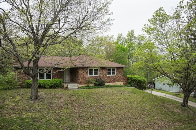 ranch-style house featuring brick siding and a front yard
