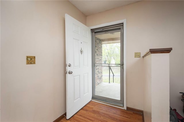 entryway with baseboards and light wood-style floors