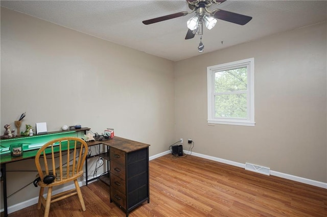 office space featuring visible vents, light wood-style flooring, and baseboards