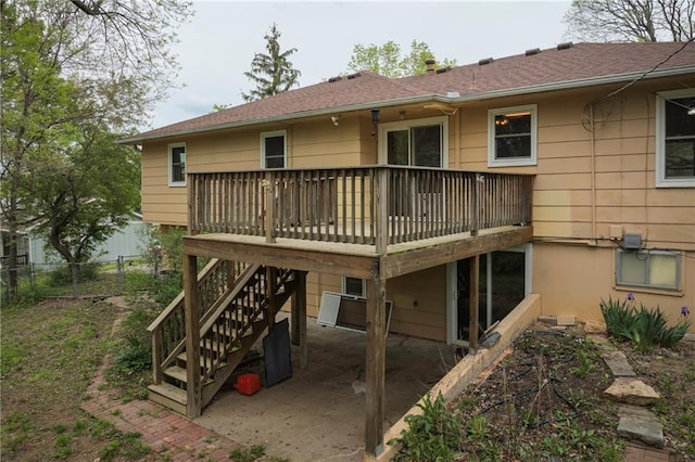 back of house with a wooden deck, a shingled roof, a patio area, and fence