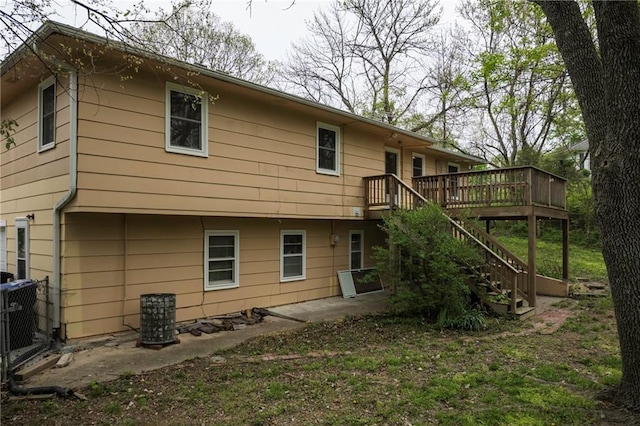 rear view of house with a patio, stairway, and a wooden deck