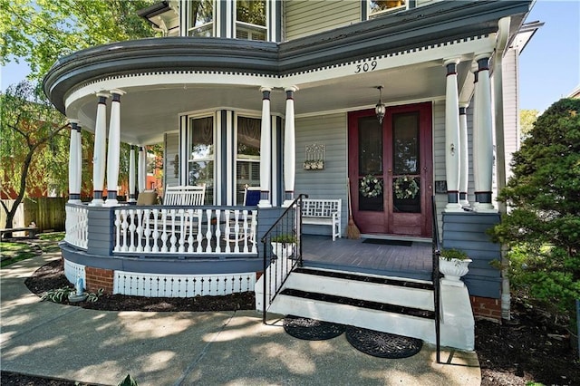 view of exterior entry with covered porch