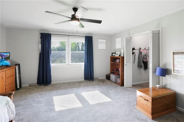 carpeted bedroom featuring ceiling fan, baseboards, and crown molding