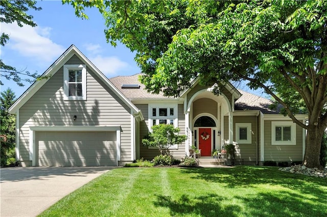 5510 W 153rd Ter, Overland Park, KS 66223 - view of front of property featuring an attached garage, driveway, a front yard, and a shingled roof